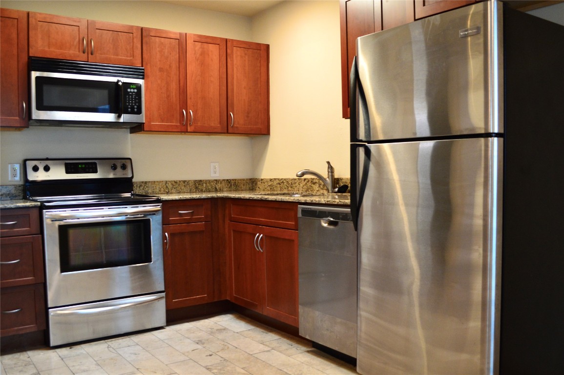 2800 Cole Street, Unit 202C Austin, TX 78705 - Photo 8 of 16 a kitchen with stainless steel appliances granite countertop a refrigerator and a microwave