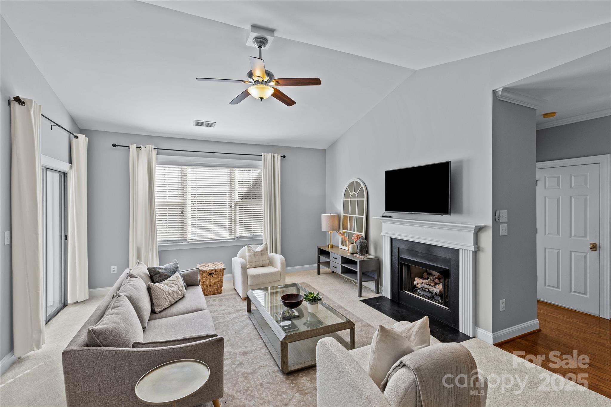 5601 Fairview Road, Unit 24 Charlotte, NC 28209 - Photo 11 of 38 a living room with furniture a fireplace and a flat screen tv