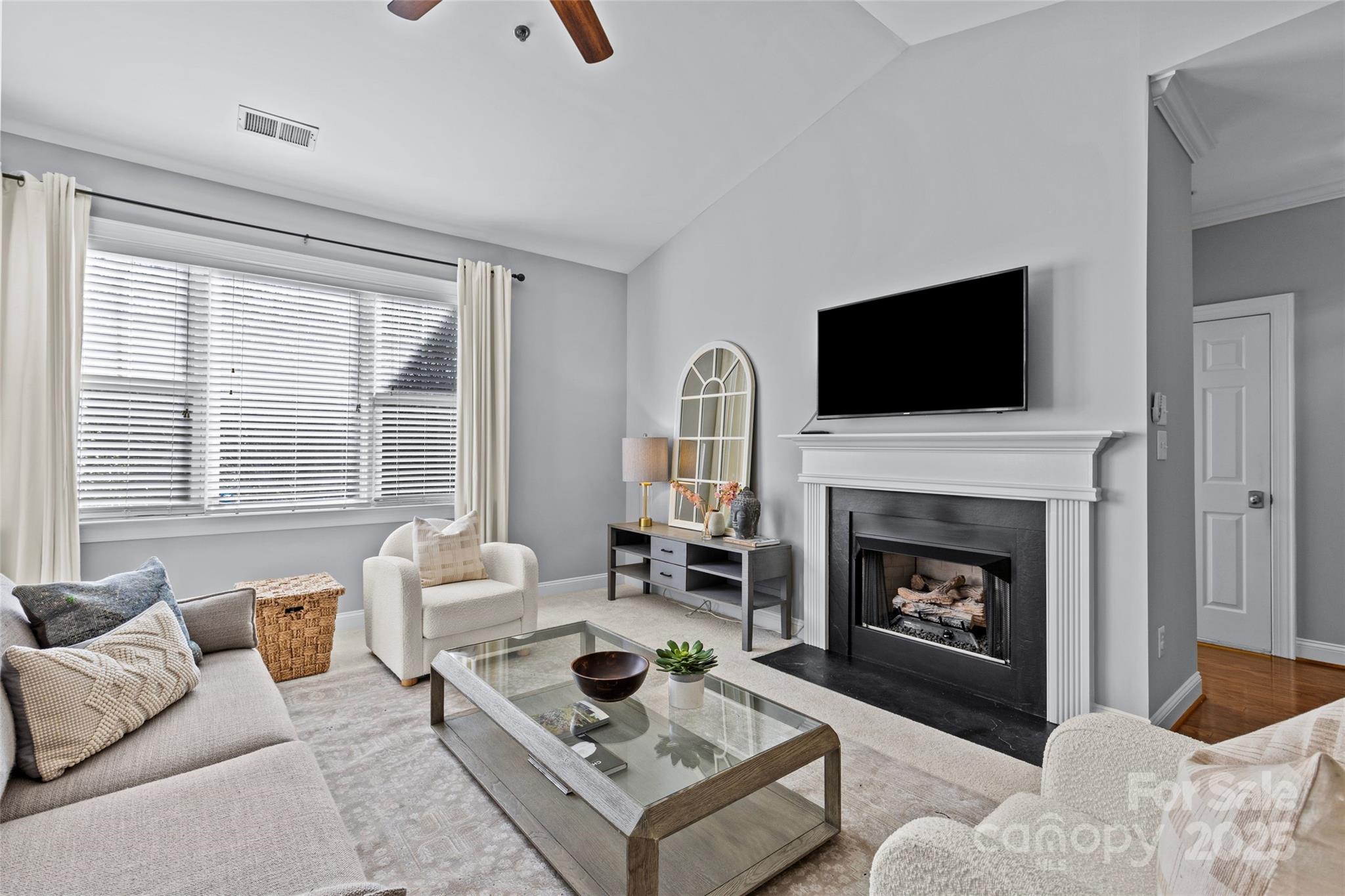 5601 Fairview Road, Unit 24 Charlotte, NC 28209 - Photo 12 of 38 a living room with furniture a fireplace and a flat screen tv