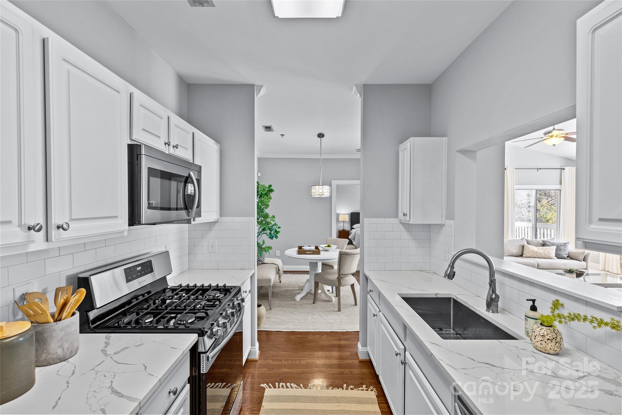 5601 Fairview Road, Unit 24 Charlotte, NC 28209 - Photo 17 of 38 a kitchen with stainless steel appliances granite countertop a stove a sink and a microwave