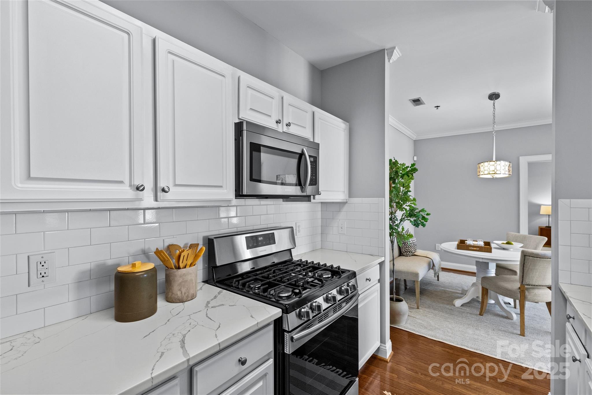 5601 Fairview Road, Unit 24 Charlotte, NC 28209 - Photo 18 of 38 a kitchen with stainless steel appliances granite countertop a stove a sink and a microwave
