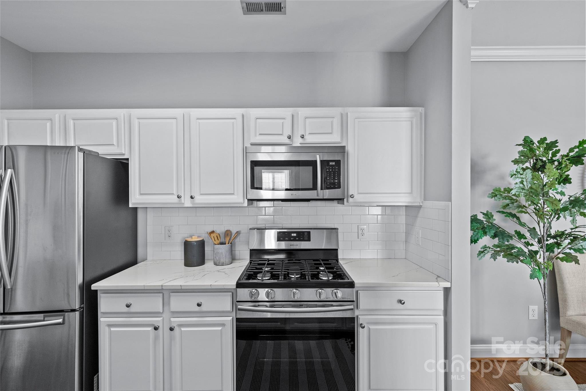 5601 Fairview Road, Unit 24 Charlotte, NC 28209 - Photo 21 of 38 a kitchen with stainless steel appliances a stove a microwave and a potted plant