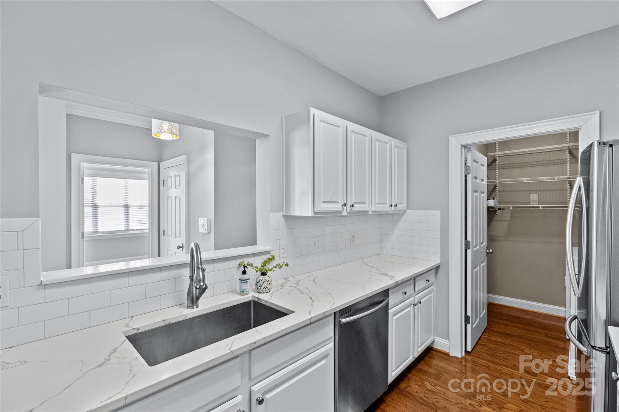 5601 Fairview Road, Unit 24 Charlotte, NC 28209 - Photo 24 of 38 a kitchen with a sink and refrigerator