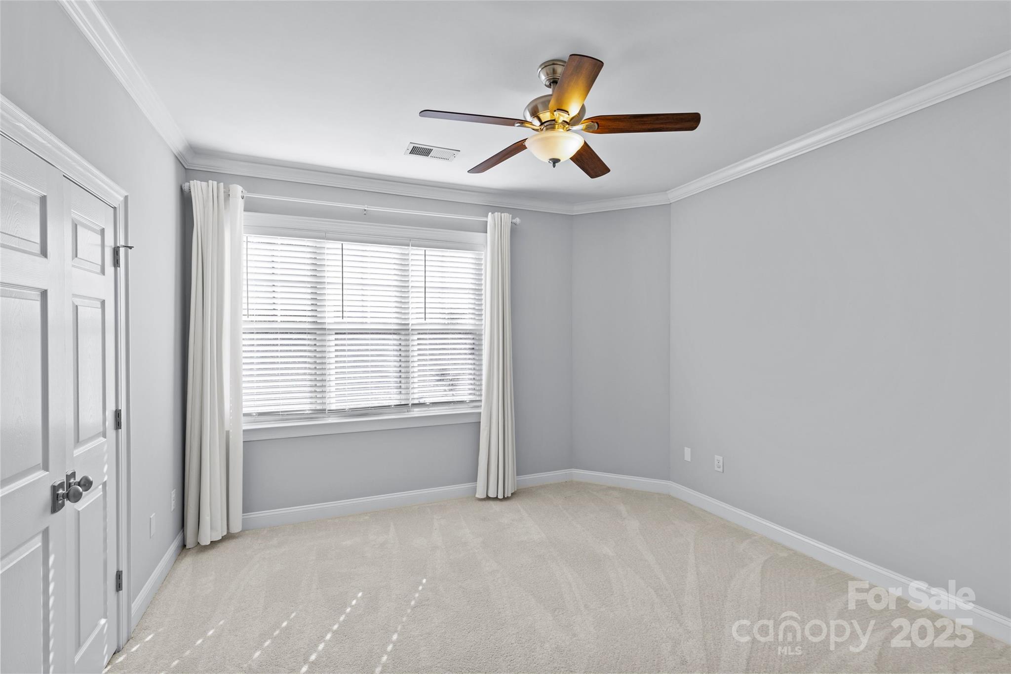 5601 Fairview Road, Unit 24 Charlotte, NC 28209 - Photo 31 of 38 an empty room with a ceiling fan and windows