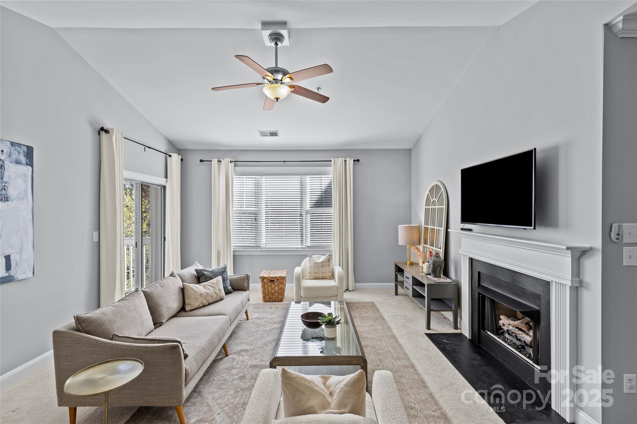 5601 Fairview Road, Unit 24 Charlotte, NC 28209 - Photo 10 of 38 a living room with furniture a flat screen tv and a fireplace