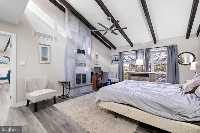 a bedroom with a bed a table and chair