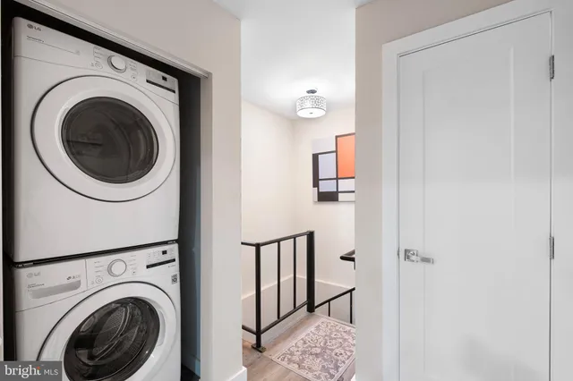 a view of a hallway with washer and dryer