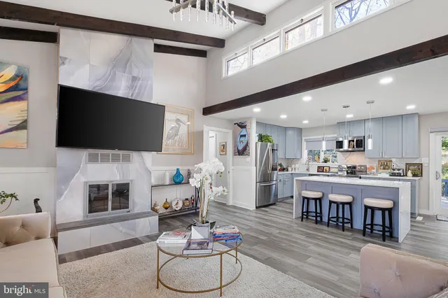 a living room with fireplace furniture and a flat screen tv