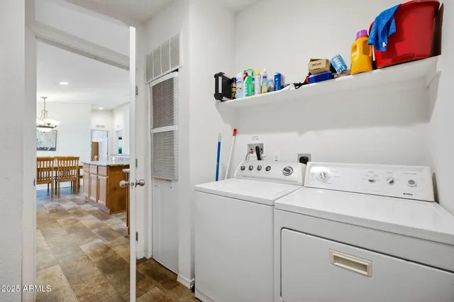 a view of storage and utility room with washer and dryer