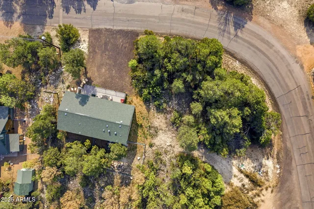 an aerial view of a house with a yard and garden