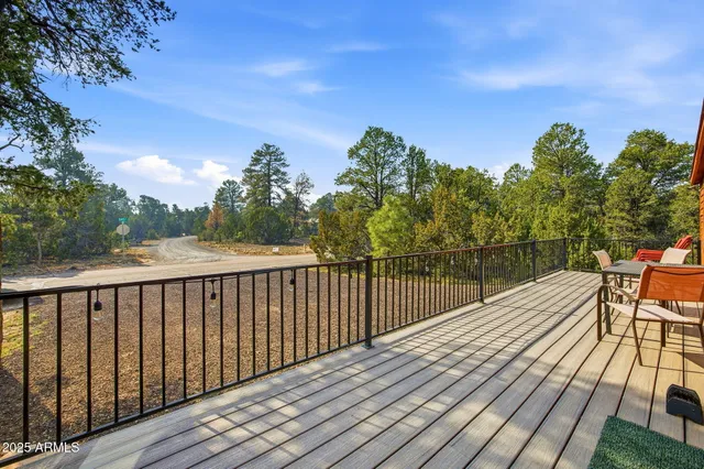 a balcony with wooden floor and city view