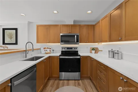 a kitchen with a sink stove and microwave