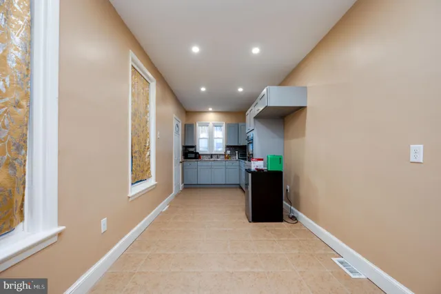 a kitchen with granite countertop white cabinets stainless steel appliances and window
