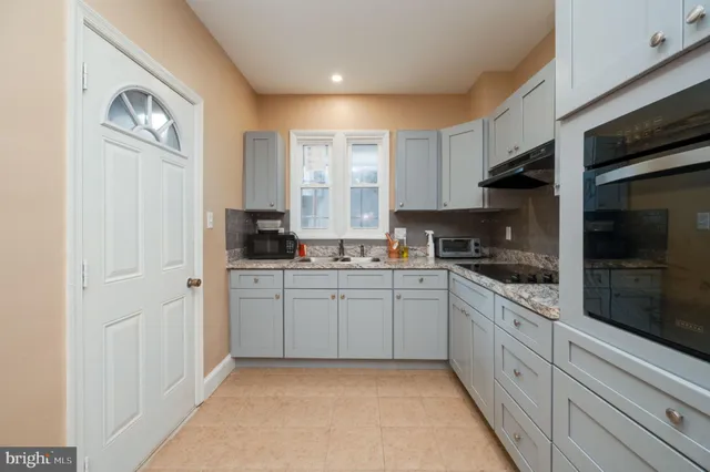 a kitchen with sink cabinets and window