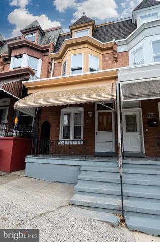 a front view of a residential apartment building with a yard
