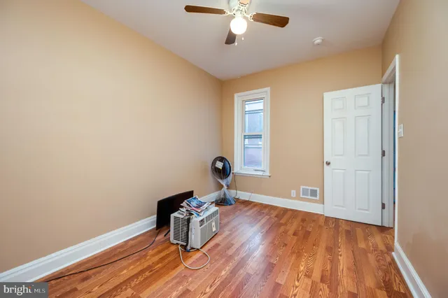 a view of a bedroom with wooden floor