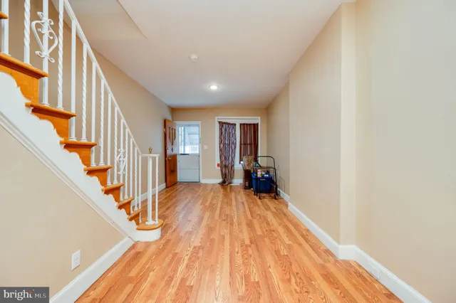 a view of entryway with wooden floor and stairs