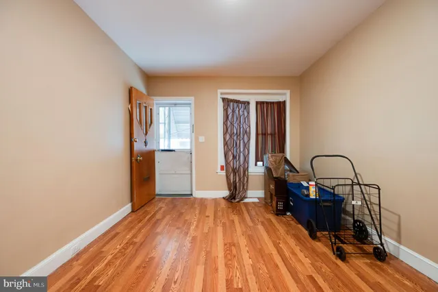 a view of a kitchen with refrigerator and windows
