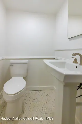 a view of a room with wooden floor and a sink