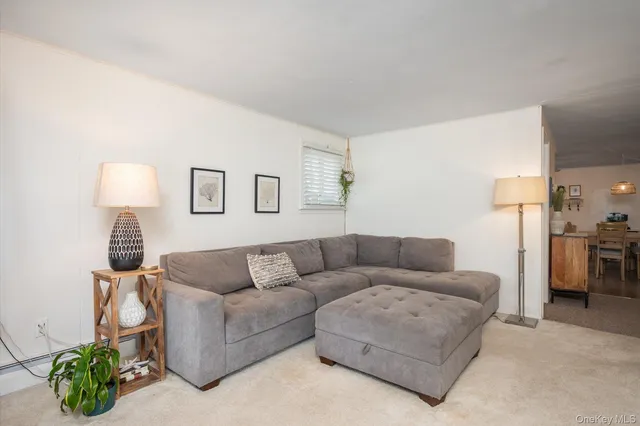 a living room with furniture and a lamp