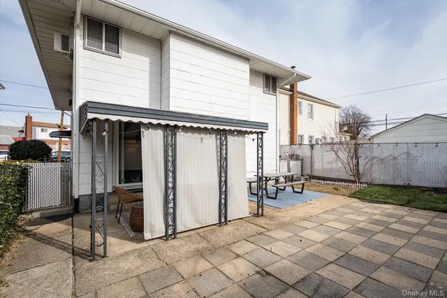 a backyard of a house with table and chairs