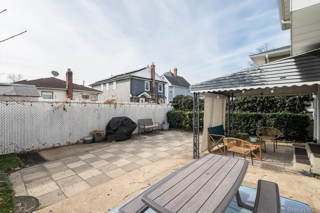 a view of a house with backyard and sitting area
