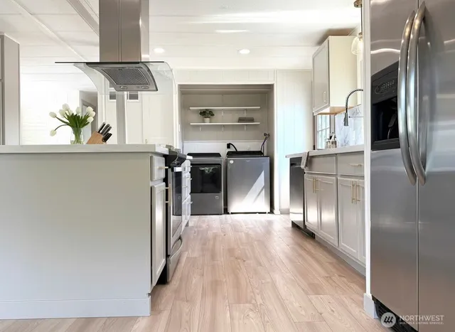 a kitchen with stainless steel appliances a refrigerator and a stove