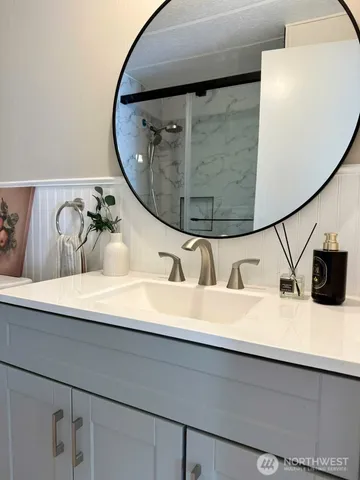 closeup of a sink with a mirror and vanity