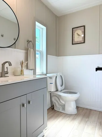 a bathroom with a toilet sink and mirror