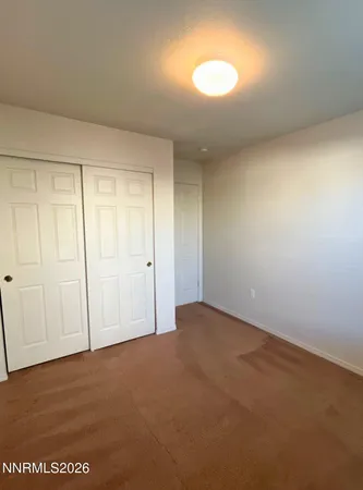 a view of an empty room and a window