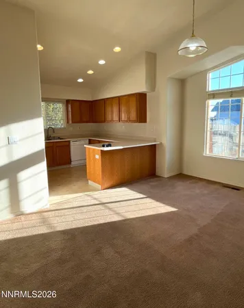 a view of kitchen with stainless steel appliances granite countertop lots of counter top space