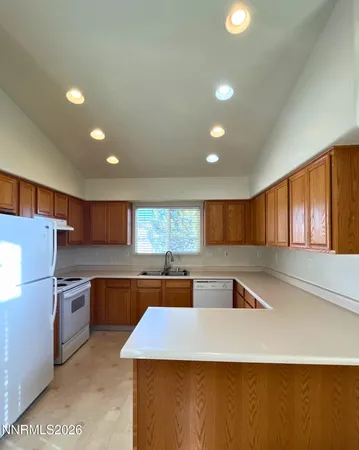 a kitchen with stainless steel appliances granite countertop a sink counter space and cabinets