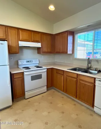 a kitchen with granite countertop a sink stainless steel appliances and cabinets