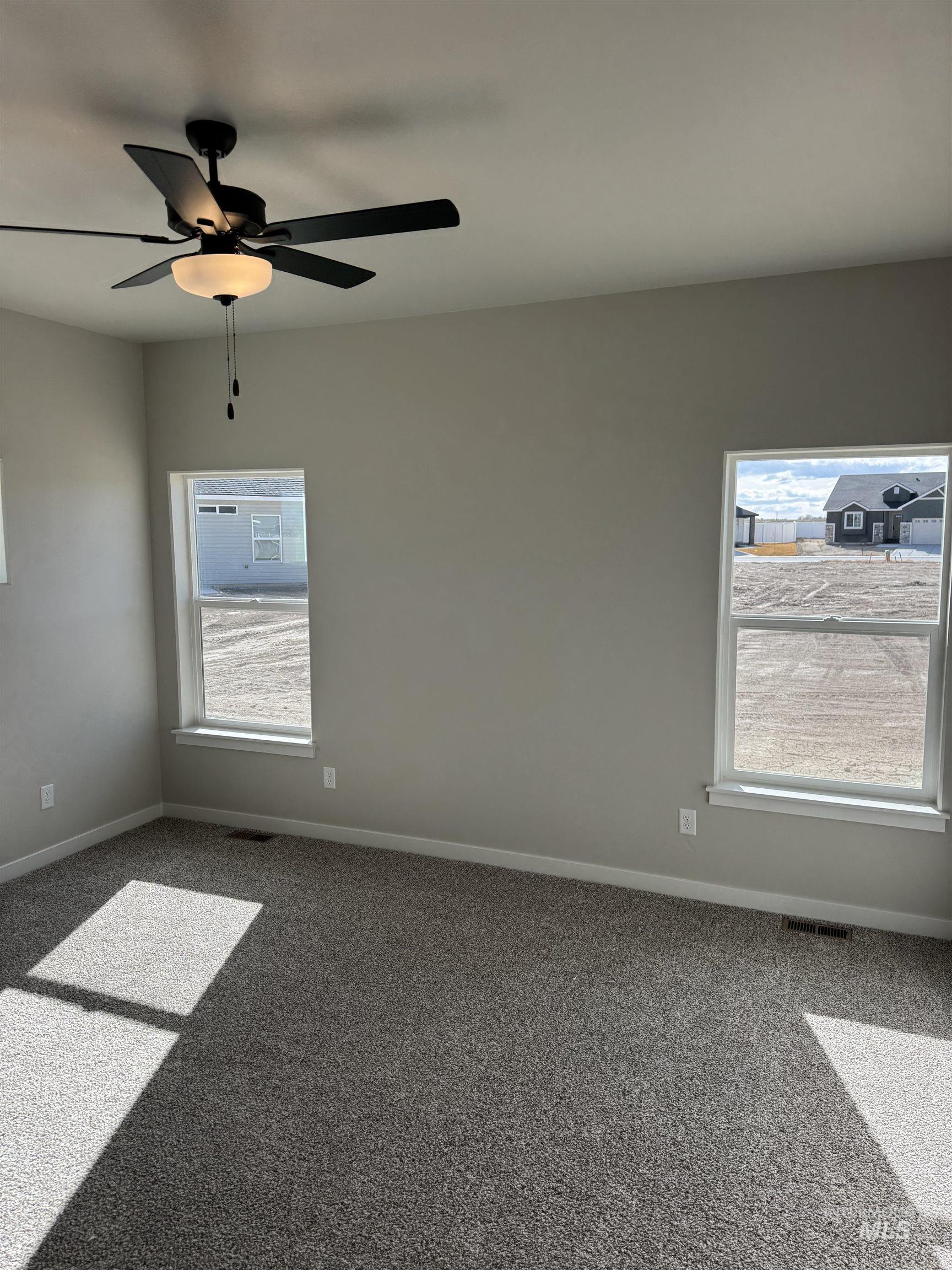 2064 Harrison Street South Twin Falls, ID 83301 - Photo 12 of 29 Carpeted empty room featuring ceiling fan and healthy amount of natural light