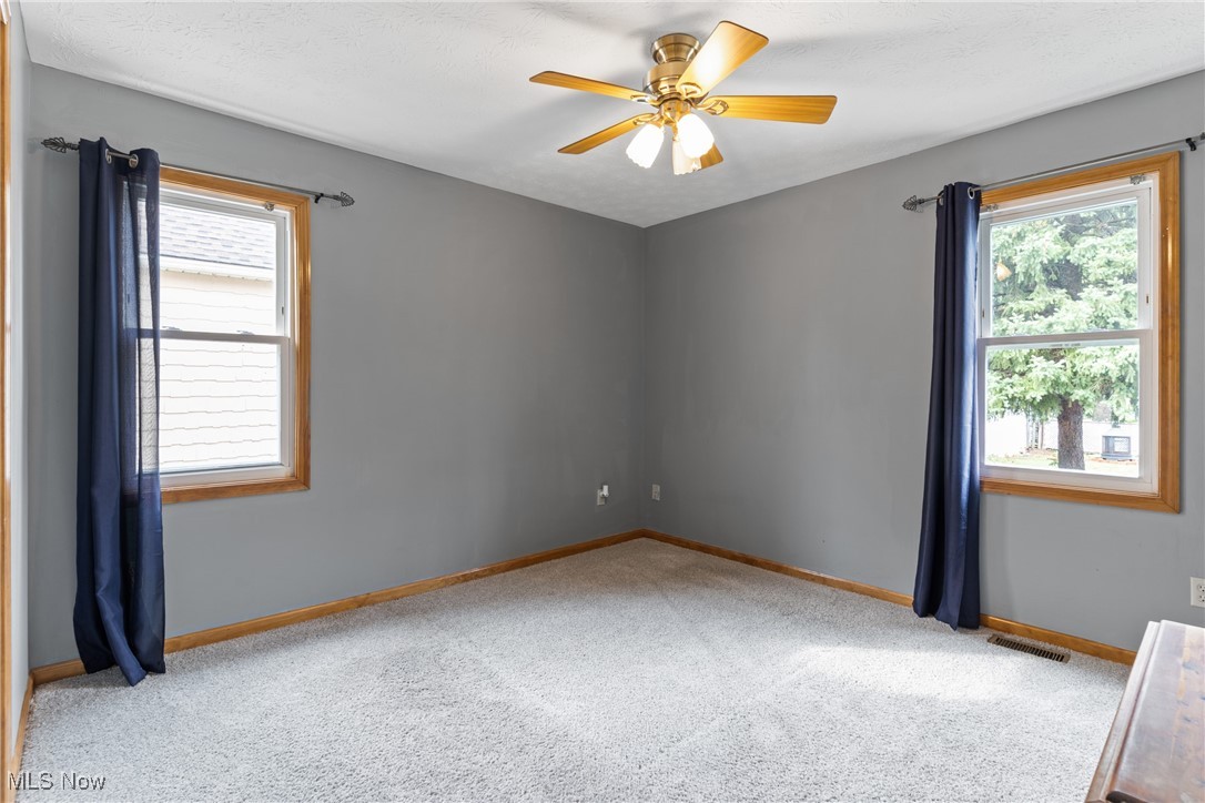 7514 Spring Garden Road Cleveland, OH 44129 - Photo 17 of 30 Main floor bedroom featuring light carpeting and a ceiling fan