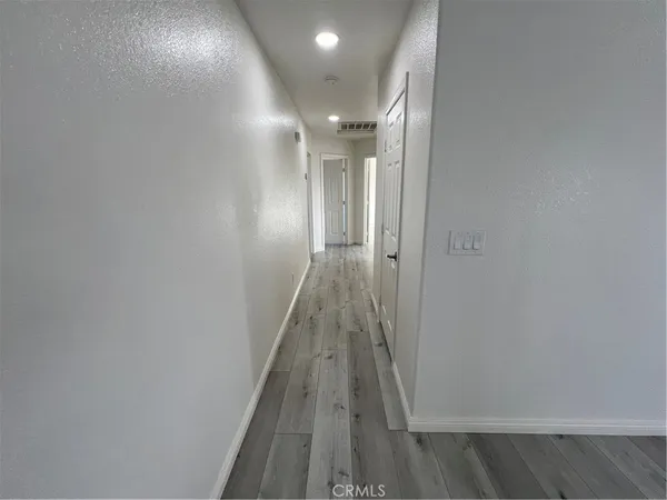 wooden floor in an empty room with a fireplace