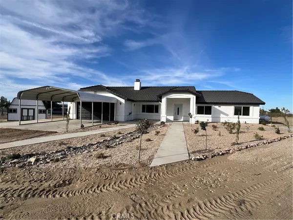 a kitchen with stainless steel appliances granite countertop a refrigerator a stove top oven a sink and dishwasher
