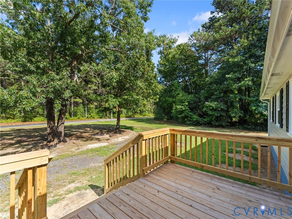 6927 Carsley Road Waverly, VA 23890 - Photo 43 of 51 Wood-plank outdoor deck with natural wood railings