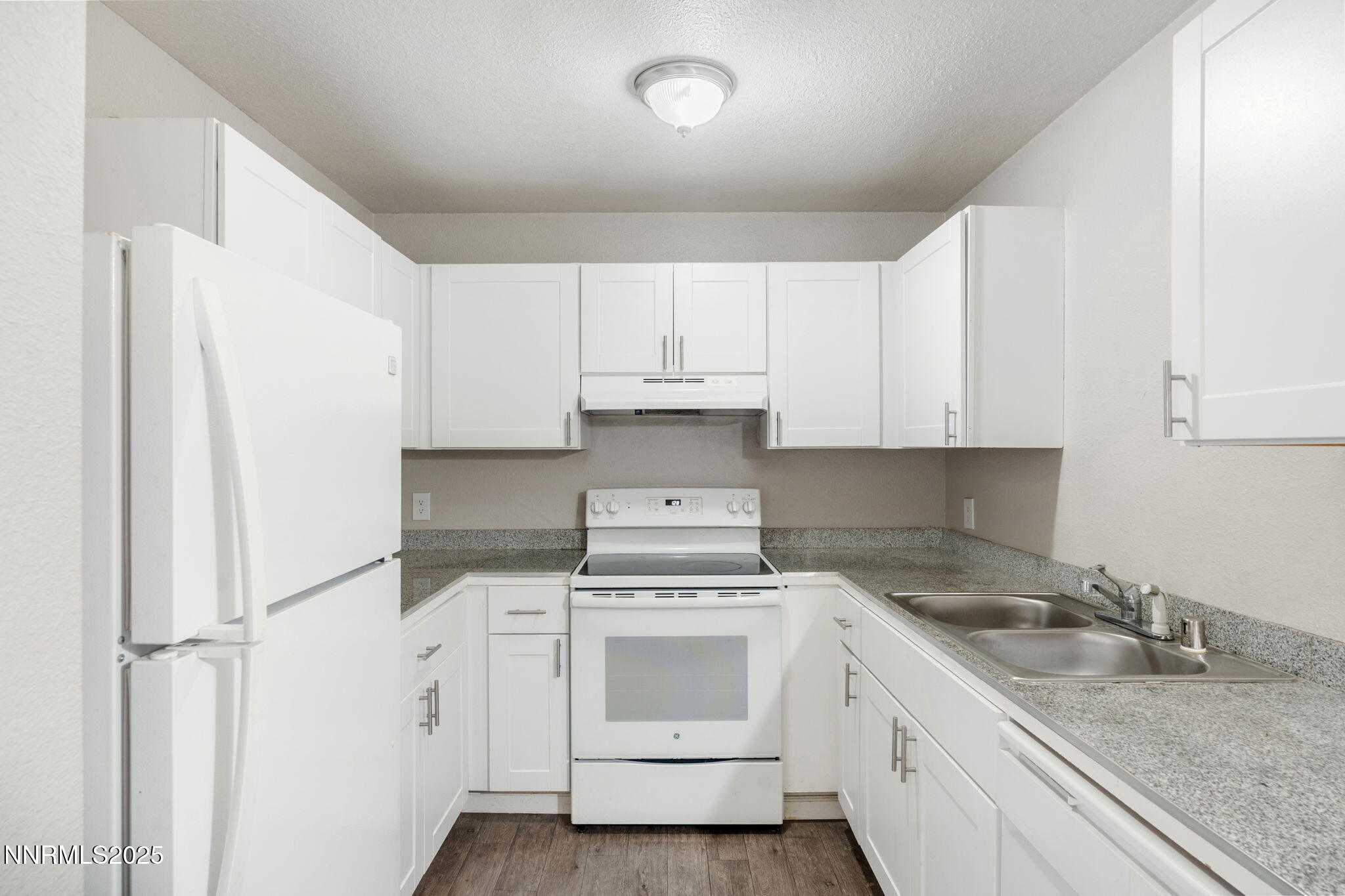 2085 Highview Court, Unit 2 Reno, NV 89512 - Photo 16 of 26 a kitchen with granite countertop white cabinets and white appliances