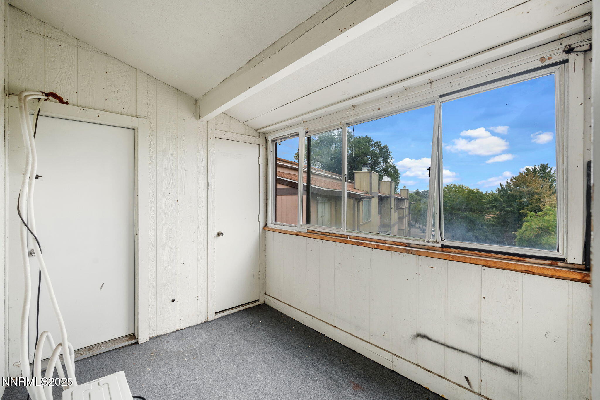 2085 Highview Court, Unit 2 Reno, NV 89512 - Photo 25 of 26 a view of a large room with a large window and chandelier
