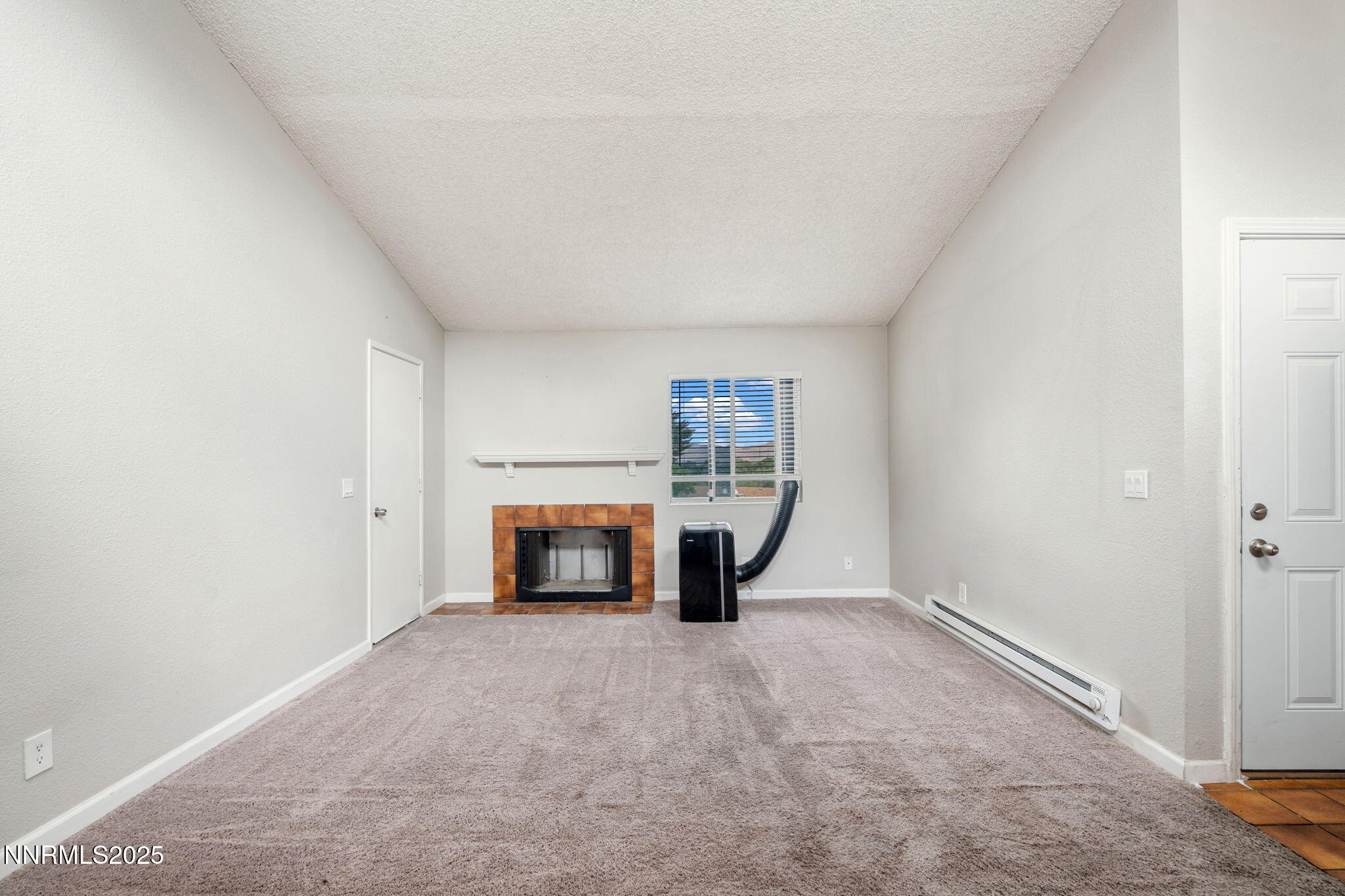 2085 Highview Court, Unit 2 Reno, NV 89512 - Photo 6 of 26 a view of empty room with fireplace and window