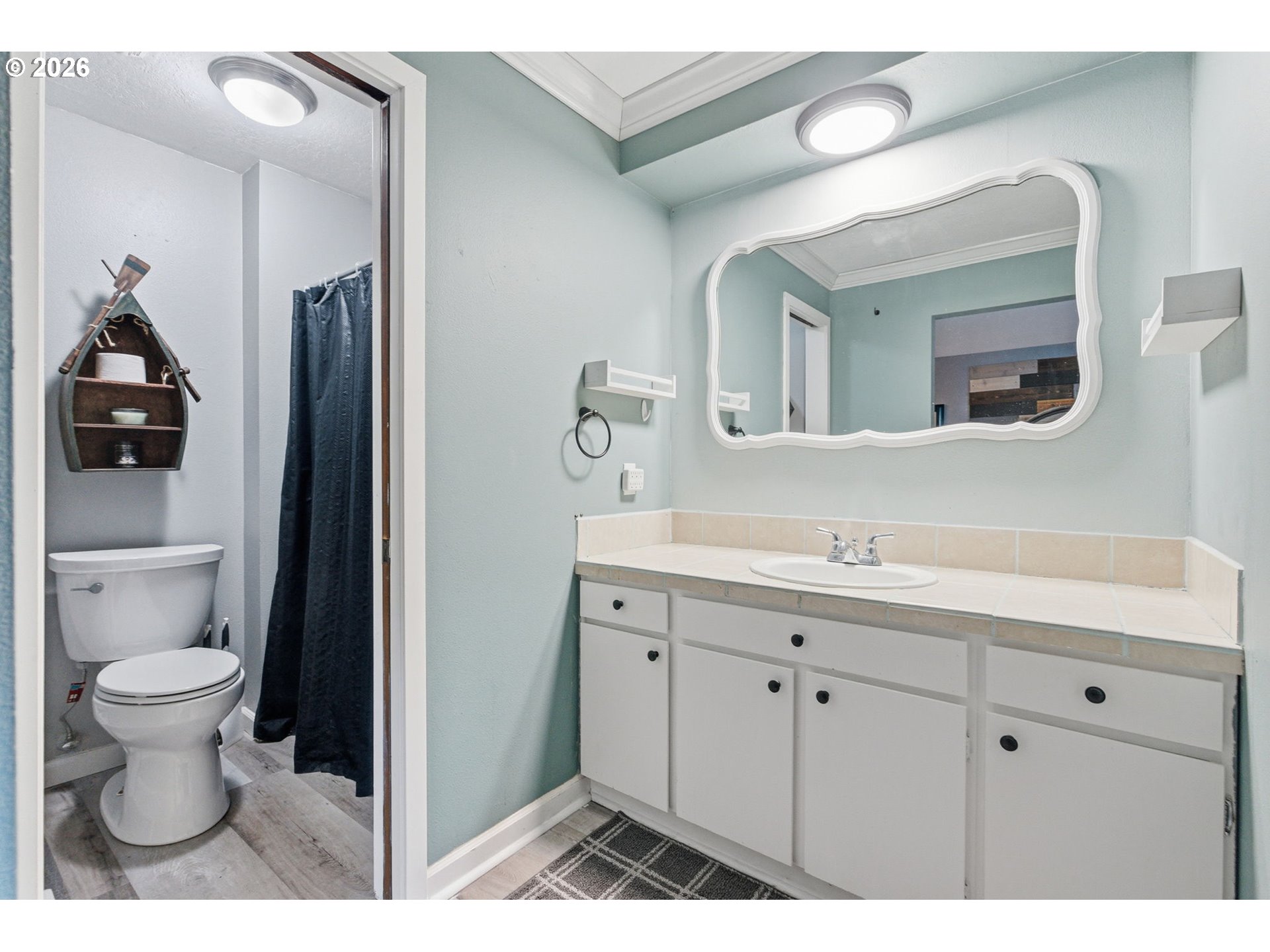 1801 North Cedar Street Newberg, OR 97132 - Photo 15 of 30 a bathroom with a toilet sink and mirror