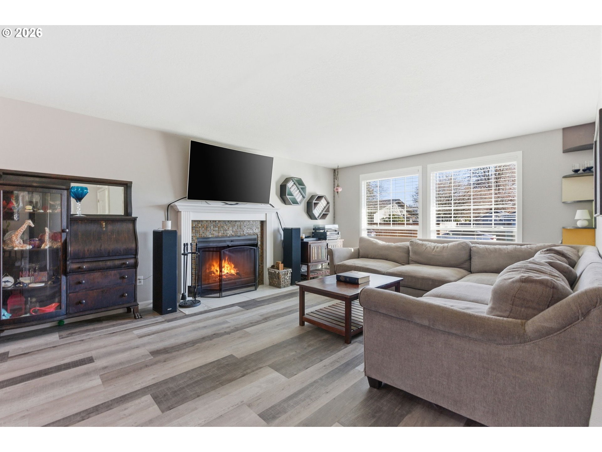 1801 North Cedar Street Newberg, OR 97132 - Photo 2 of 30 a living room with furniture a flat screen tv and a fireplace