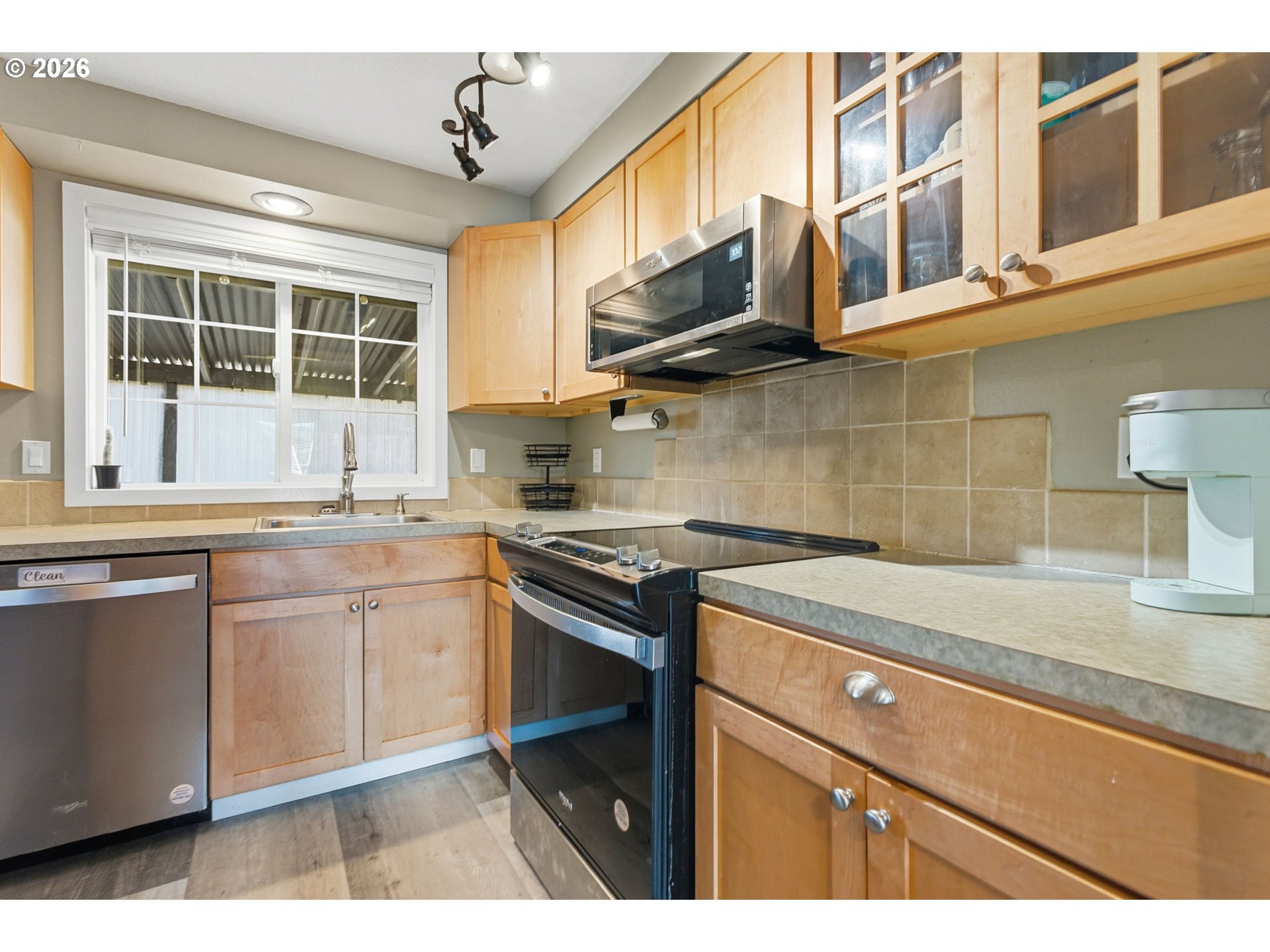 1801 North Cedar Street Newberg, OR 97132 - Photo 9 of 30 a kitchen with stainless steel appliances granite countertop a sink stove and cabinets