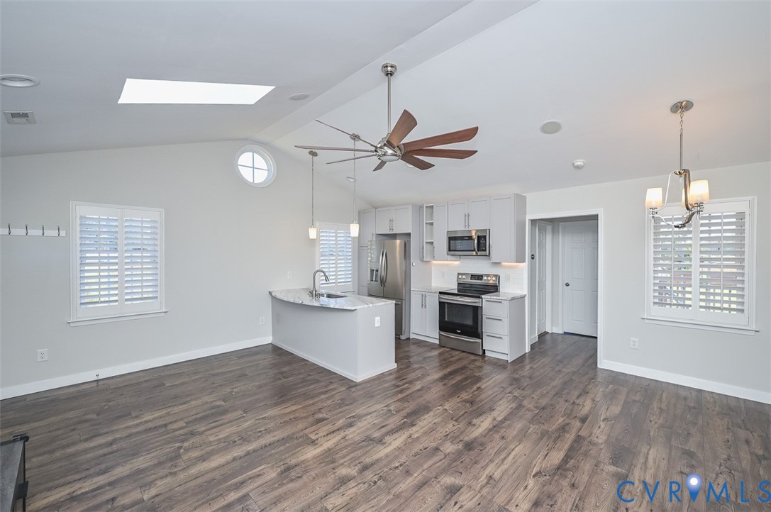8441 Buffin Road Henrico, VA 23231 - Photo 11 of 50 a view of a kitchen with sink microwave and wooden floor