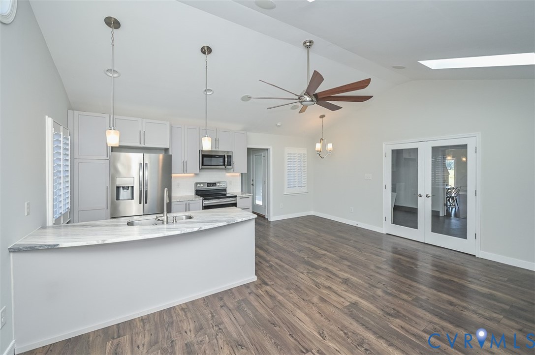 8441 Buffin Road Henrico, VA 23231 - Photo 15 of 50 a large kitchen with stainless steel appliances kitchen island a large counter top and wooden floors