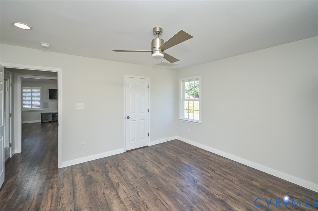 8441 Buffin Road Henrico, VA 23231 - Photo 18 of 50 an empty room with wooden floor ceiling fan and windows