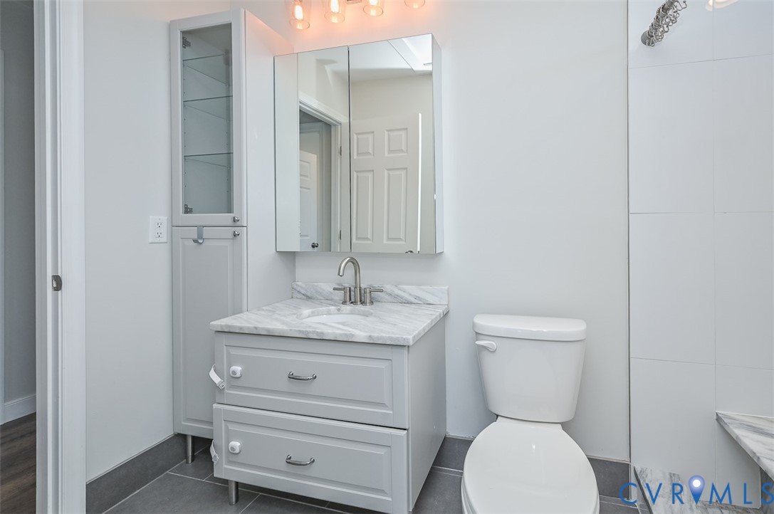 8441 Buffin Road Henrico, VA 23231 - Photo 23 of 50 a bathroom with a toilet sink and mirror