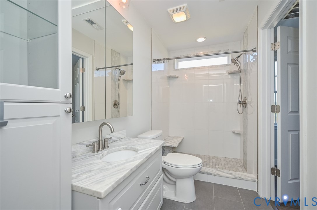 8441 Buffin Road Henrico, VA 23231 - Photo 24 of 50 a bathroom with a granite countertop sink toilet and shower