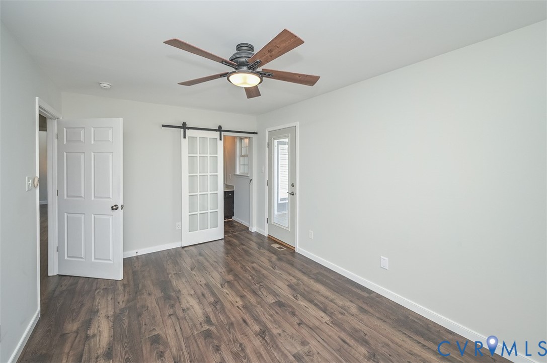 8441 Buffin Road Henrico, VA 23231 - Photo 26 of 50 a view of an empty room with wooden floor and a ceiling fan